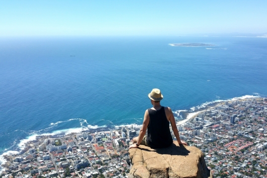 Man on the edge of a rock on Lion's Head, Cape Town, South Africa